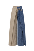 Two aprons, one beige and one blue denim, on a brown background