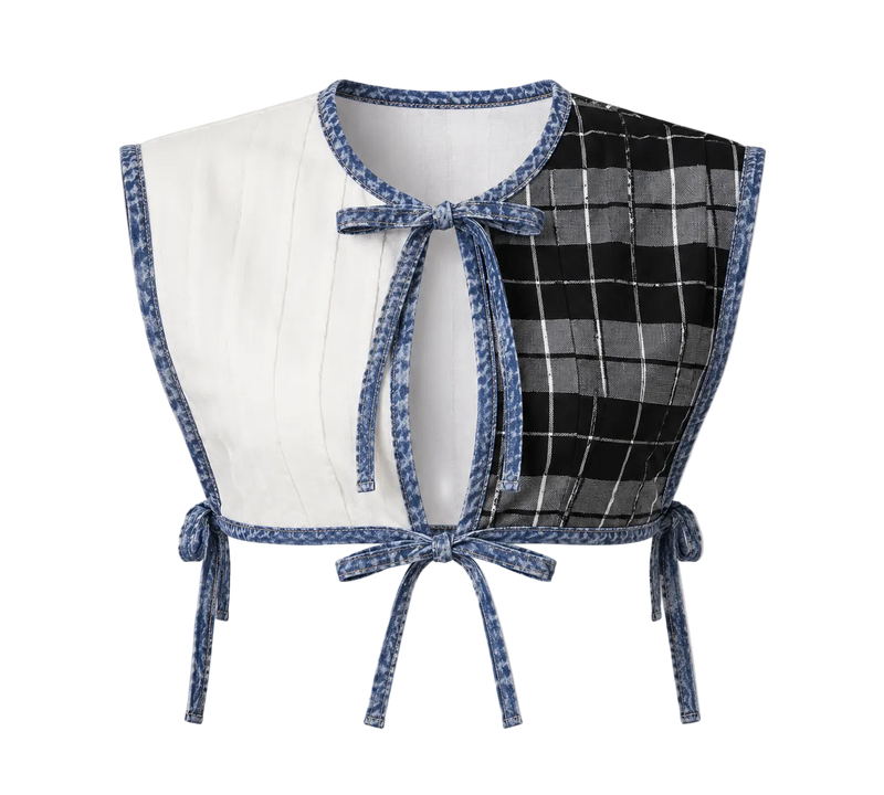 Two-piece outfit with a white top and plaid skirt on a gray background