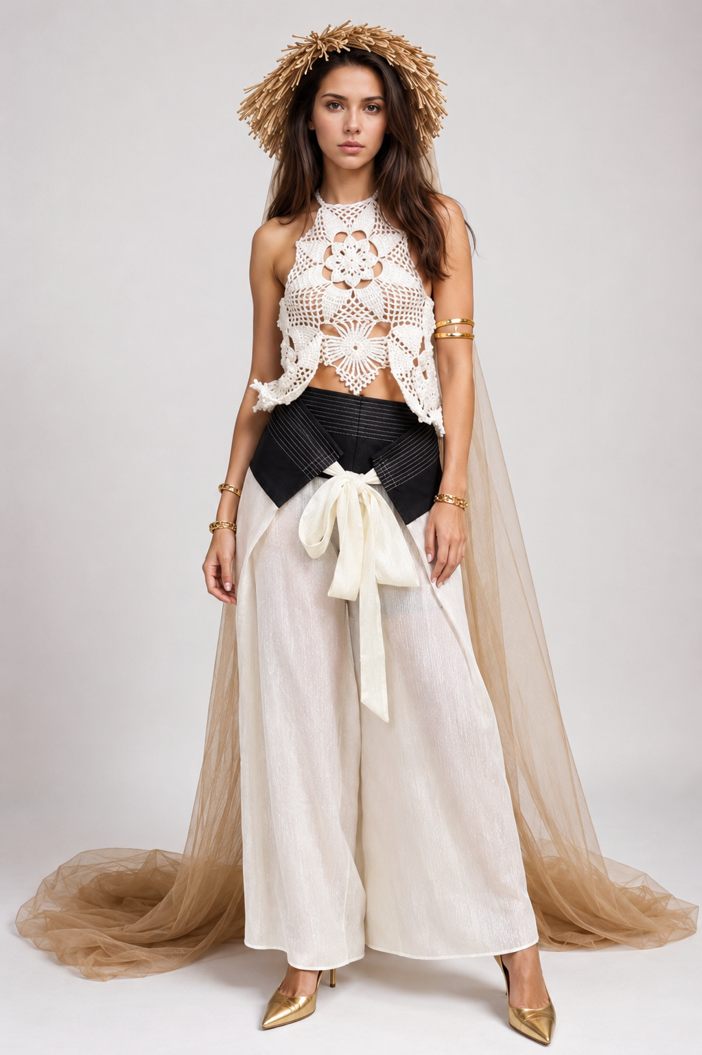 Woman wearing a stylish outfit with a white lace top, black and white skirt, and beige flowing garment on a plain background.