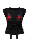 Black top with plaid accents on a beige background